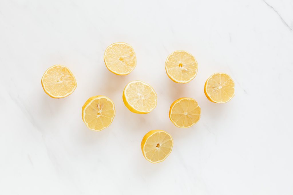 Get healthier without crash diets. Lemon halves on a marble chopping board backdrop. Alkaline, New Year